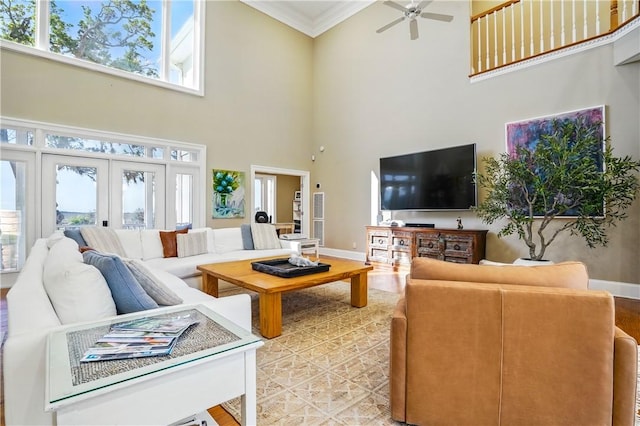 164 Sunrise Dr, Saint Simons Island, GA 31522 - living room featuring baseboards, a high ceiling, ornamental molding, and a healthy amount of sunlight