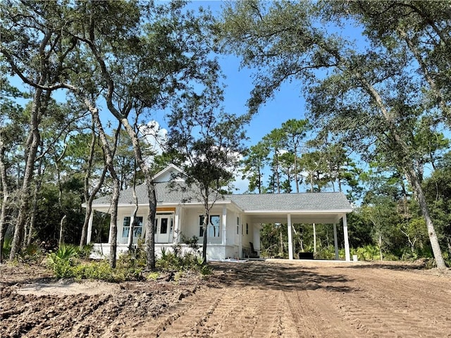 view of front of home featuring a carport and a porch