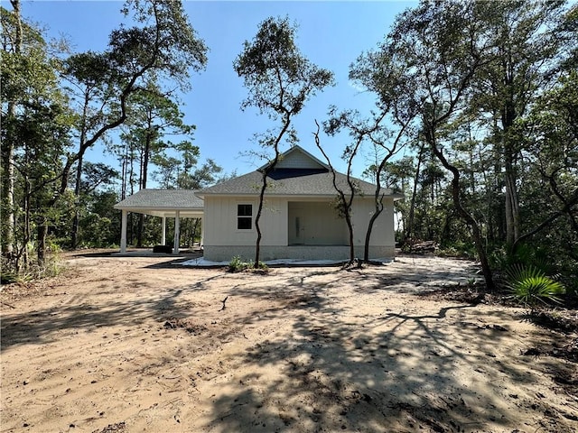 back of house with a carport