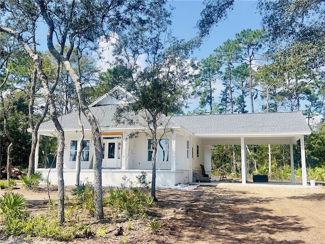 view of front of home with a carport and a porch