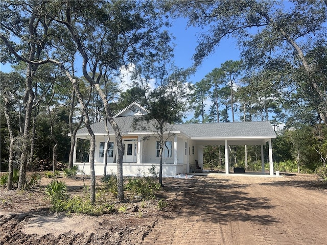 view of front of house with a carport and covered porch