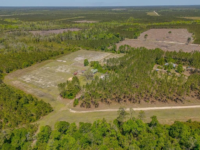 drone / aerial view featuring a wooded view