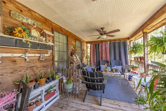 sunroom / solarium with a ceiling fan