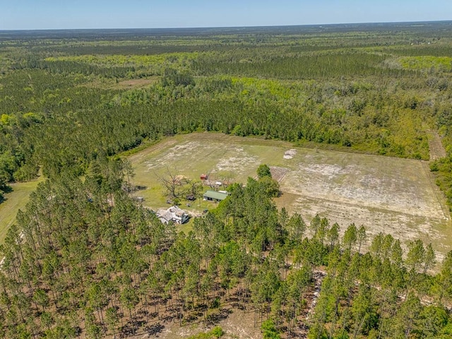 bird's eye view with a wooded view