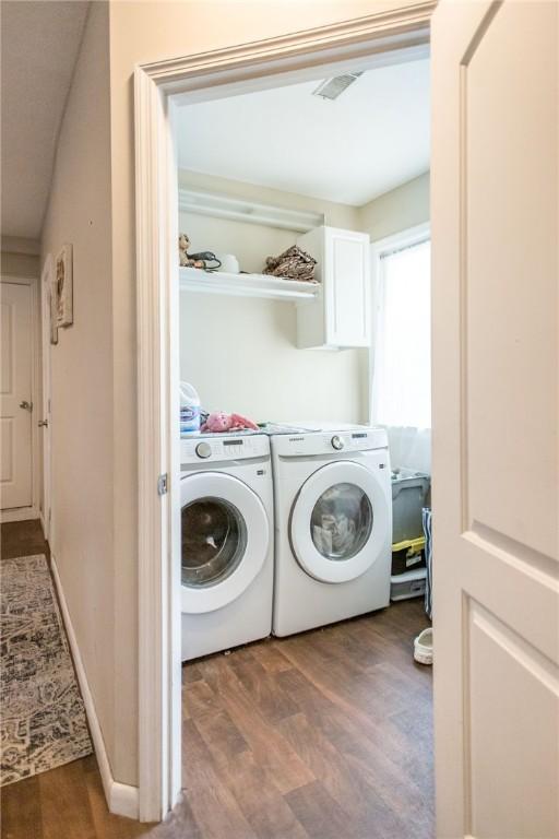 1002 Cherokee Cir, Waycross, GA 31501 - laundry room with washer and clothes dryer and wood finished floors