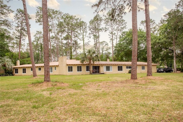 1002 Cherokee Cir, Waycross, GA 31501 - rear view of house featuring a chimney and a yard