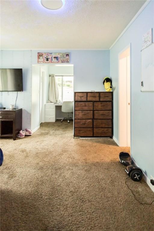 1002 Cherokee Cir, Waycross, GA 31501 - carpeted bedroom featuring an office area and ornamental molding