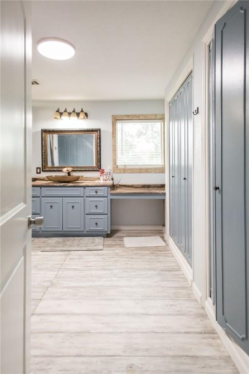 1002 Cherokee Cir, Waycross, GA 31501 - bathroom with vanity, wood finished floors, and a bath
