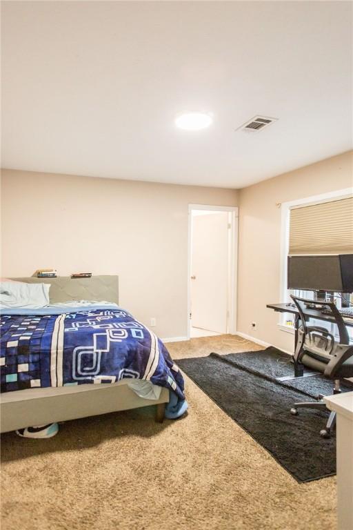 1002 Cherokee Cir, Waycross, GA 31501 - carpeted bedroom with baseboards