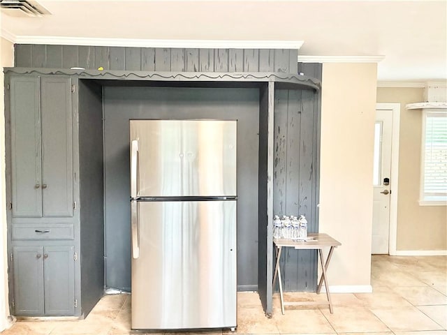 1002 Cherokee Cir, Waycross, GA 31501 - kitchen with freestanding refrigerator, crown molding, light tile patterned flooring, baseboards, and gray cabinets