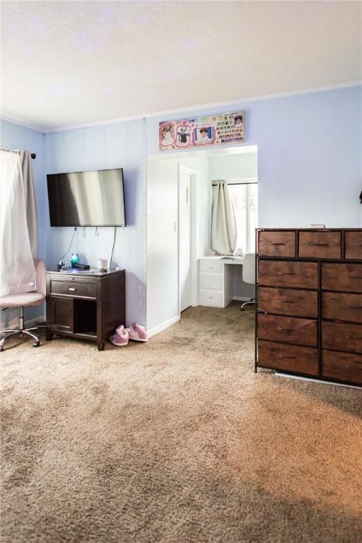1002 Cherokee Cir, Waycross, GA 31501 - carpeted bedroom with a desk and ornamental molding