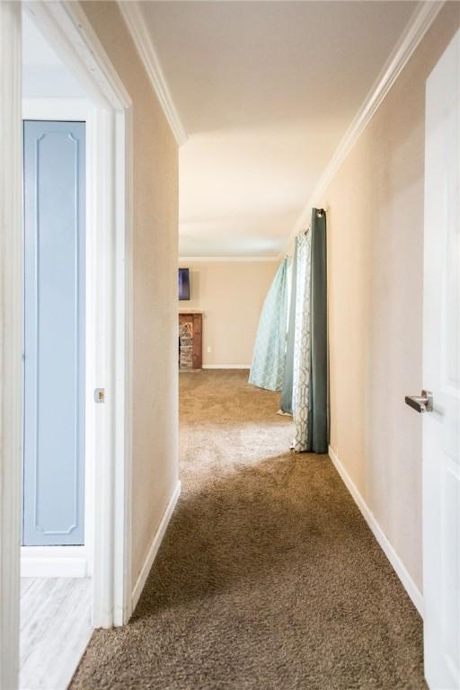 1002 Cherokee Cir, Waycross, GA 31501 - corridor with carpet flooring, ornamental molding, and baseboards