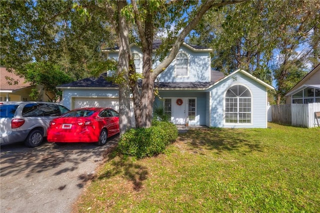 view of front of home with a front lawn and a garage