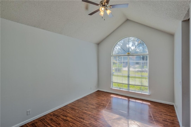 empty room with a textured ceiling, ceiling fan, lofted ceiling, and hardwood / wood-style flooring