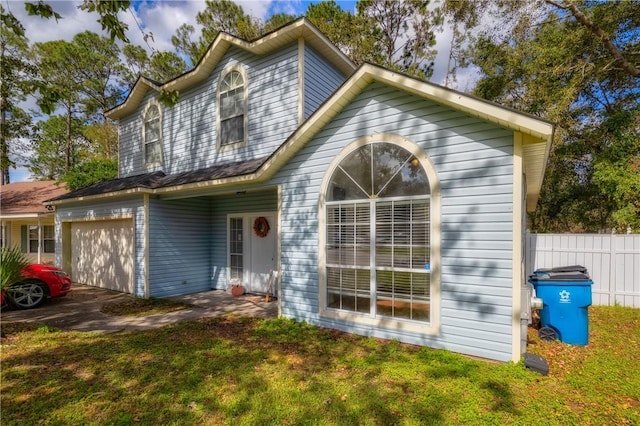 view of front facade with a front yard and a garage