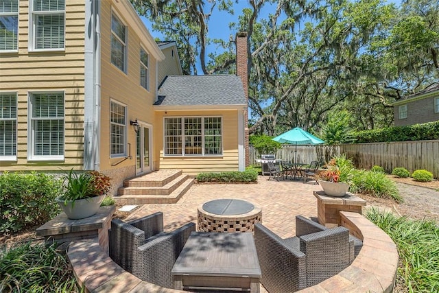 213 Five Pounds Rd, Saint Simons Island, GA 31522 - fenced backyard featuring a patio area, french doors, outdoor dining space, and an outdoor fire pit