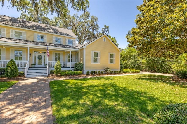 213 Five Pounds Rd, Saint Simons Island, GA 31522 - colonial house featuring covered porch and a front yard