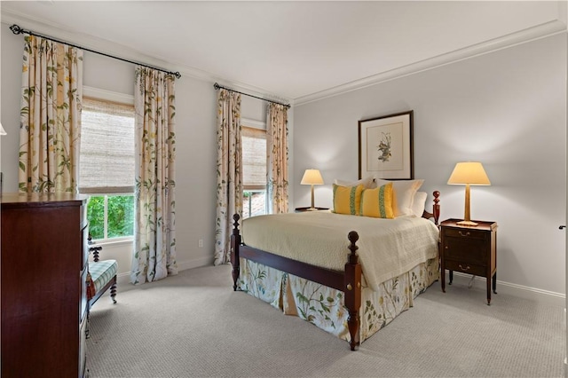 bedroom with carpet floors, baseboards, and crown molding