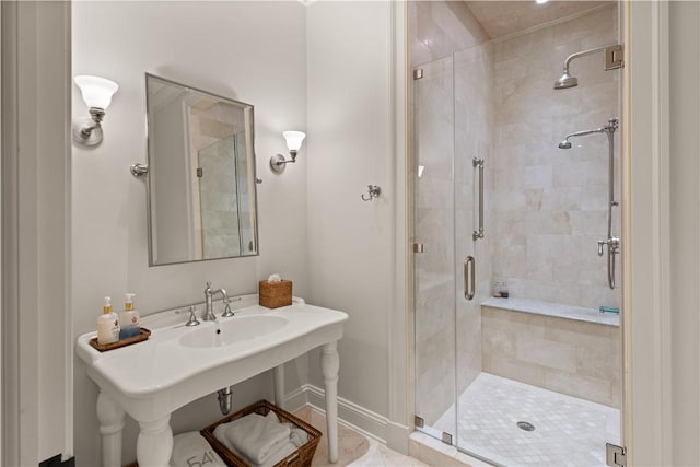 bathroom featuring a stall shower and baseboards