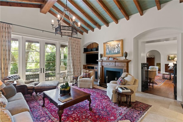 living area featuring arched walkways, a fireplace with flush hearth, french doors, high vaulted ceiling, and beam ceiling