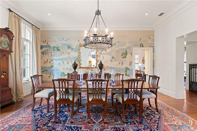 dining room with baseboards, wood finished floors, and crown molding