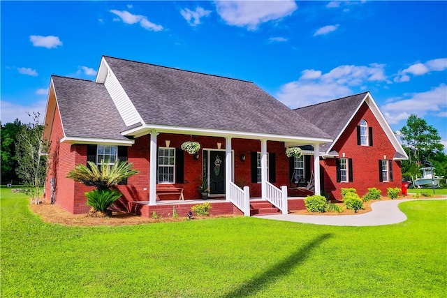 view of front facade with brick siding, roof with shingles, and a porch