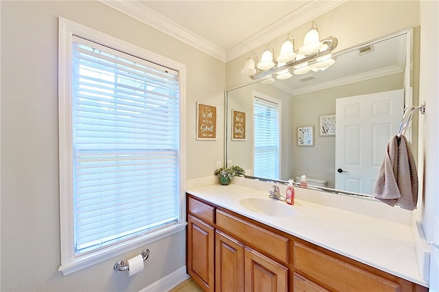 bathroom with crown molding, a wealth of natural light, toilet, and vanity