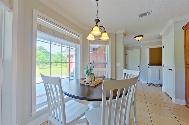 dining space featuring crown molding, visible vents, light tile patterned flooring, baseboards, and a textured ceiling