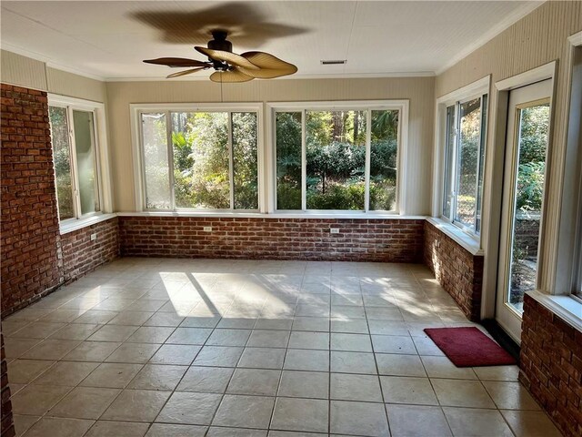 unfurnished sunroom with ceiling fan