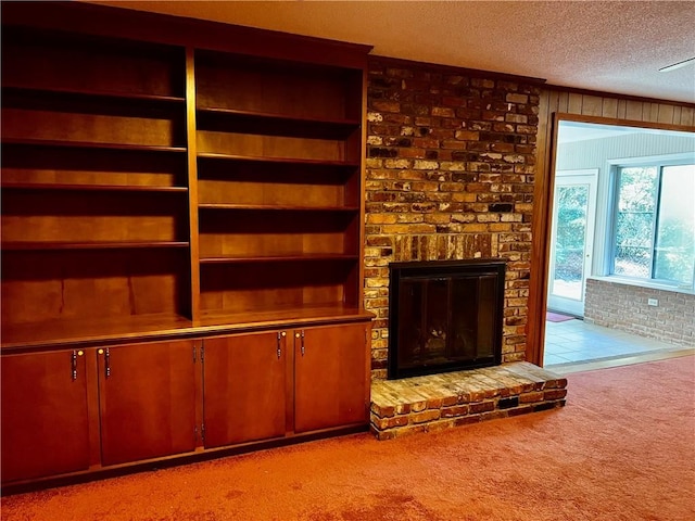 unfurnished living room featuring a textured ceiling, light carpet, wooden walls, and a brick fireplace