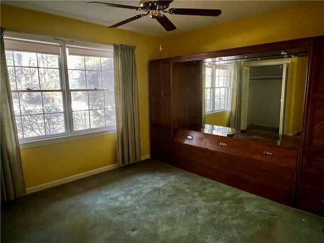 unfurnished bedroom featuring carpet and ceiling fan