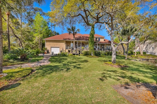 view of front of house with a garage and a front lawn