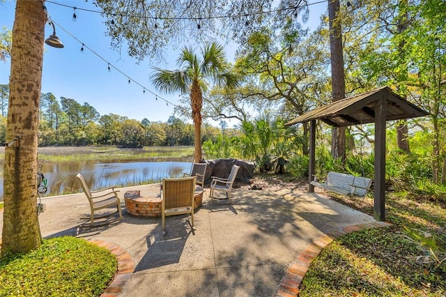 view of patio featuring a water view and an outdoor fire pit