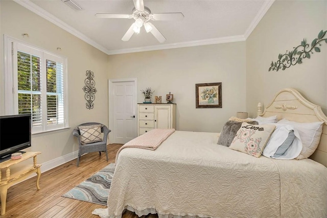 bedroom featuring ceiling fan, light hardwood / wood-style flooring, and ornamental molding