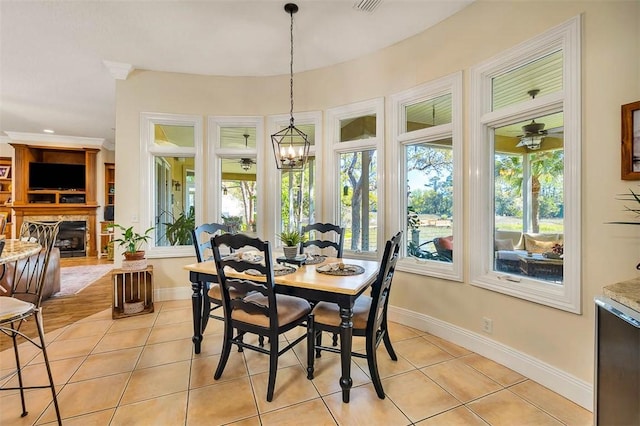 dining area featuring ceiling fan with notable chandelier and light tile patterned flooring