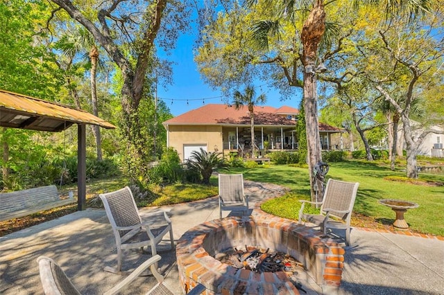 view of patio / terrace with an outdoor fire pit