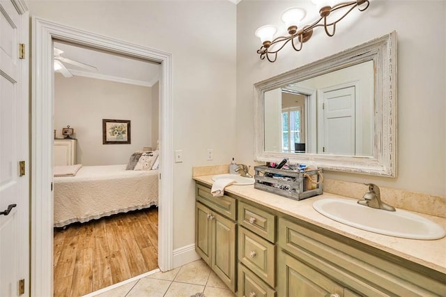 bathroom with wood-type flooring, vanity, ceiling fan, and crown molding