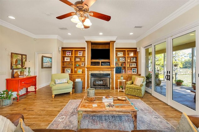 living room with french doors, light hardwood / wood-style flooring, ceiling fan, and crown molding