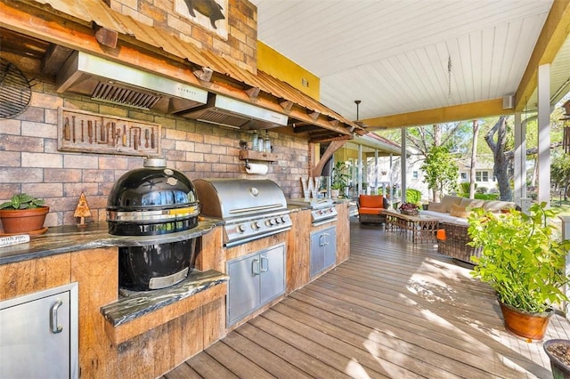 view of patio featuring grilling area, outdoor lounge area, area for grilling, and a wooden deck