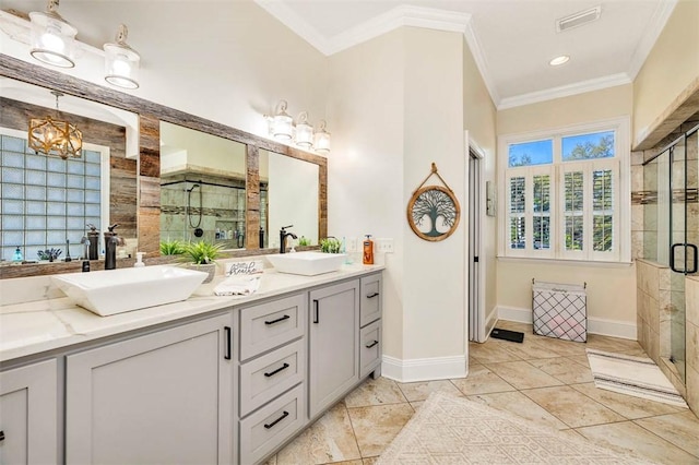 bathroom featuring a shower with door, vanity, a notable chandelier, and ornamental molding