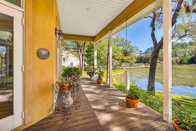 wooden deck featuring a water view and covered porch