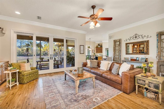 living room featuring ceiling fan, light hardwood / wood-style floors, ornamental molding, and french doors