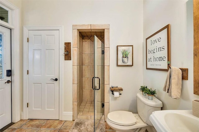 bathroom with walk in shower, tile patterned floors, and toilet