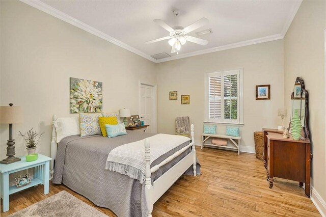 bedroom with ceiling fan, light wood-type flooring, and ornamental molding