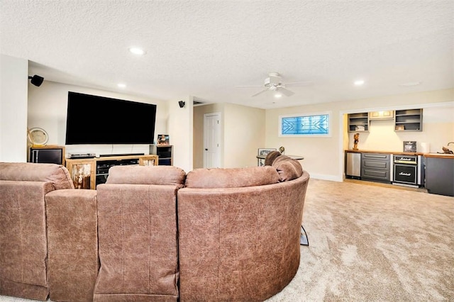 living room featuring a fireplace, a textured ceiling, light colored carpet, and ceiling fan