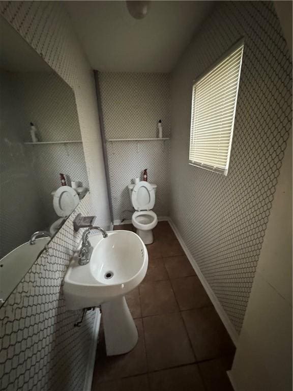 bathroom with sink, tile patterned flooring, and toilet