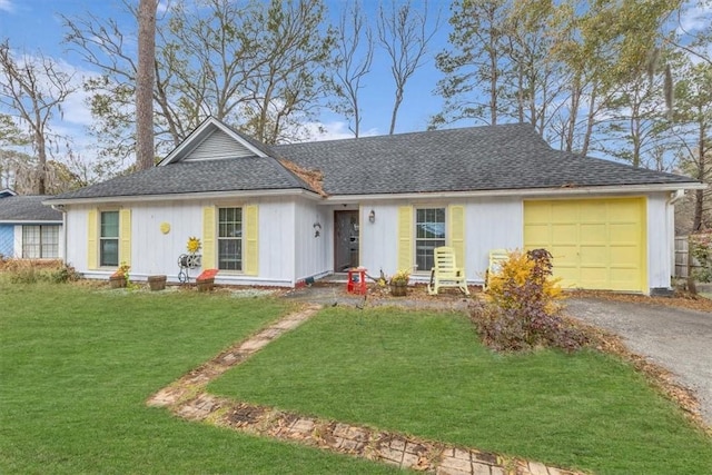 single story home with a garage and a front lawn