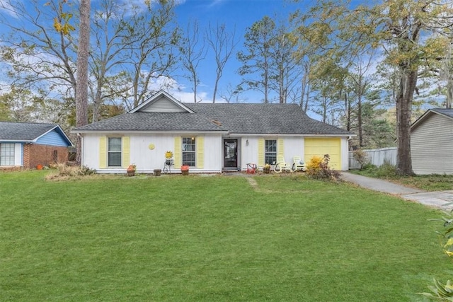 ranch-style house featuring a garage and a front yard