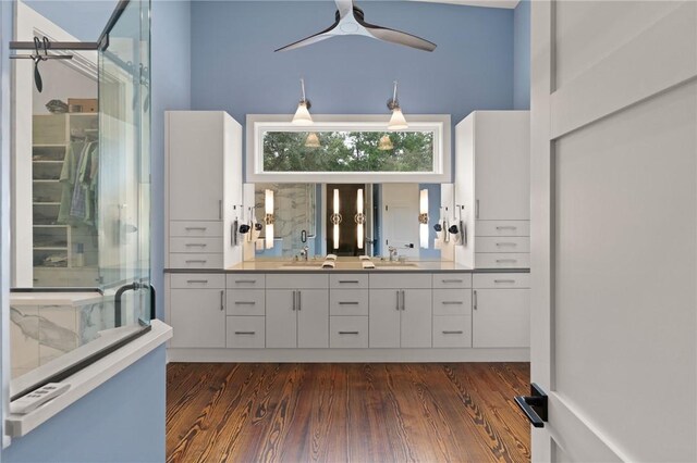 bathroom featuring hardwood / wood-style floors, vanity, ceiling fan, and walk in shower