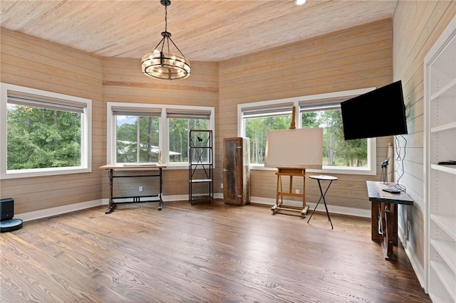 interior space featuring a chandelier, wooden walls, wood ceiling, and hardwood / wood-style flooring